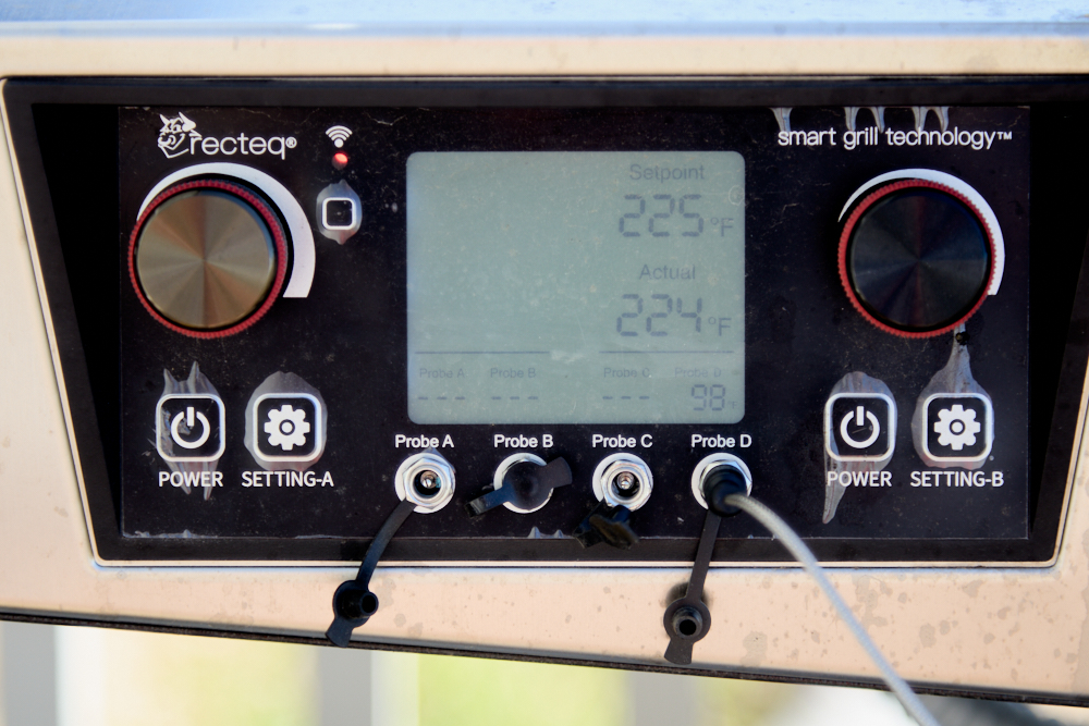 Close-up of a recteq pellet smoker control panel displaying temperature settings. The screen shows a setpoint of 225°F and an actual temperature of 224°F—perfect for smoke turkey breast, no brine needed. Several probe ports and control dials are visible.
